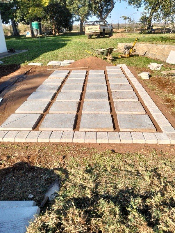 Two-tone stone patio with gravel joints and fire pit bowl