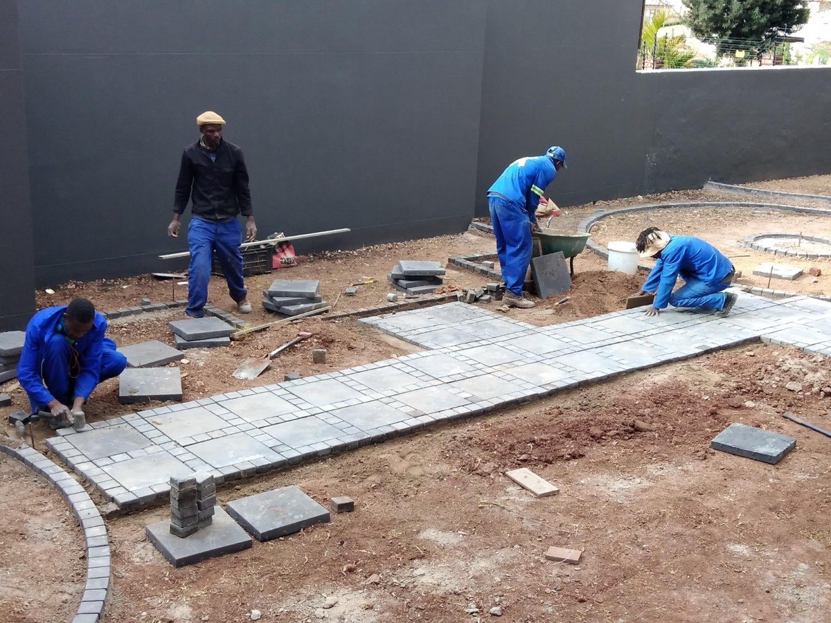 Tzaneen Paving team laying curved cobblestone patio at an upscale property